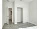 Bedroom with an open closet showcasing sliding doors and hard surface floors, complemented by a neutral wall color at 7445 Ibis Dr, Lakeland, FL 33810