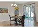 A modern dining area with stylish light fixture and a view to the outside at 7445 Ibis Dr, Lakeland, FL 33810