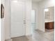 Inviting entryway featuring a white door and light colored flooring, leading to a bathroom and other rooms at 7445 Ibis Dr, Lakeland, FL 33810