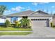 Charming single-story home with a well-manicured lawn and a two-car garage at 7445 Ibis Dr, Lakeland, FL 33810