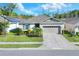 Inviting single-story home features a well-maintained lawn and a convenient two-car garage at 7445 Ibis Dr, Lakeland, FL 33810