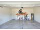 The garage features painted block walls, overhead door opener, utility sink, and space for a workbench at 7445 Ibis Dr, Lakeland, FL 33810