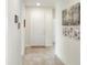 Bright hallway with neutral walls, tiled flooring, and decorative artwork at 7445 Ibis Dr, Lakeland, FL 33810