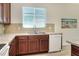 The kitchen with stainless steel sink, and dishwasher under a window offers plenty of counter space at 7445 Ibis Dr, Lakeland, FL 33810