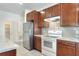 The kitchen features stainless steel refrigerator, white appliances, and cabinets with light countertops, providing ample space at 7445 Ibis Dr, Lakeland, FL 33810