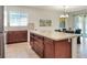 The kitchen features a large island, stainless appliances and a view to the outside at 7445 Ibis Dr, Lakeland, FL 33810