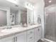 Bright bathroom with dual sinks, granite countertops, and a large glass-enclosed shower at 7576 Sw 108 Th St, Ocala, FL 34476