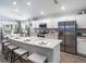 Spacious kitchen featuring stainless steel appliances, a large island, and white cabinets with stylish countertops at 7576 Sw 108 Th St, Ocala, FL 34476