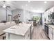 Open concept kitchen with island seating, stainless steel appliances, and ample counter space at 7576 Sw 108 Th St, Ocala, FL 34476