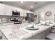 Bright kitchen featuring stainless steel appliances, white cabinets, and a spacious island with seating at 7576 Sw 108 Th St, Ocala, FL 34476