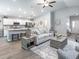 Open concept living room with modern furnishings, ample natural light, and view of the kitchen at 7576 Sw 108 Th St, Ocala, FL 34476