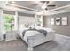 Lovely primary bedroom features a large bed, carpet, and a neutral color scheme at 7576 Sw 108 Th St, Ocala, FL 34476