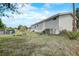 Exterior with lawn, air conditioner, and fire pit, as well as the side of the home at 900 Saddlewood Blvd, Lakeland, FL 33809