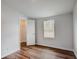 A simple bedroom with a window and a closet with wood-look flooring at 900 Saddlewood Blvd, Lakeland, FL 33809