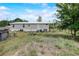 View of the home with gray siding and white trim on a grassy lot at 900 Saddlewood Blvd, Lakeland, FL 33809