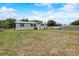 View of a home with gray siding and white trim, with a pickup truck parked out front at 900 Saddlewood Blvd, Lakeland, FL 33809