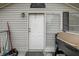 Close-up of a white front door with gray trim, a storm door, and a grill at 900 Saddlewood Blvd, Lakeland, FL 33809