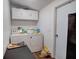Laundry room featuring modern appliances and folding table at 900 Saddlewood Blvd, Lakeland, FL 33809