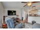 Comfortable living room featuring a ceiling fan and seamless flow to the kitchen at 900 Saddlewood Blvd, Lakeland, FL 33809