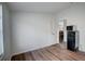 A simple room with wood-look flooring. Includes a small fridge at 900 Saddlewood Blvd, Lakeland, FL 33809