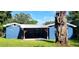 Back exterior featuring a covered porch and a well-maintained lawn at 1024 31St Nw St, Winter Haven, FL 33881