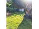 Lush backyard featuring a shed, a barbecue pit and a large tree at 1024 31St Nw St, Winter Haven, FL 33881