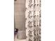 Bathroom with neutral toned tile and a decorative leaf pattern shower curtain at 1024 31St Nw St, Winter Haven, FL 33881