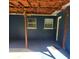 Cozy covered patio with dark blue painted block, wooden pillars, and string lights at 1024 31St Nw St, Winter Haven, FL 33881