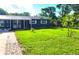 Well-manicured front yard with lush green grass and mature trees surrounding the property at 1024 31St Nw St, Winter Haven, FL 33881