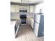 Well-lit kitchen with stainless steel appliances, granite counters and white cabinetry at 1024 31St Nw St, Winter Haven, FL 33881
