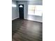 Bright living room with sleek flooring and ample natural light from the window at 1024 31St Nw St, Winter Haven, FL 33881