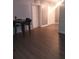 Spacious living room featuring a dark wood-look floor and seating at the counter at 1024 31St Nw St, Winter Haven, FL 33881