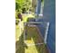 View of a side yard with gate, air conditioner and blue siding at 1024 31St Nw St, Winter Haven, FL 33881
