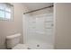 Bathroom showcasing a toilet and new shower unit with built in shelving, and natural light at 1116 Durham Dr, Lakeland, FL 33809