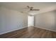 Comfortable bedroom featuring hard wood floors, a ceiling fan, and neutral tones creating a relaxing atmosphere with natural light at 1116 Durham Dr, Lakeland, FL 33809