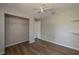 Bedroom with a ceiling fan, wood floors, closet and built-in shelving at 1116 Durham Dr, Lakeland, FL 33809