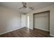 Bedroom featuring wood floors, a ceiling fan, and closet for easy storage at 1116 Durham Dr, Lakeland, FL 33809