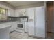 Functional kitchen featuring white appliances and ample cabinet space providing a clean and efficient area for meal preparation with tile floors at 1116 Durham Dr, Lakeland, FL 33809