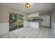 Bright kitchen with white cabinets, appliances, breakfast bar and sliding glass doors to the outside, offering a functional layout at 1116 Durham Dr, Lakeland, FL 33809