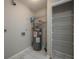 Utility Room with storage shelving, tile floor and a hot water heater at 1116 Durham Dr, Lakeland, FL 33809