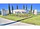 Community entrance sign with beautiful landscaping and trees at 1537 Leamington Ln, Winter Haven, FL 33884
