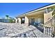 Spacious covered patio with stone pillars and a ceiling fan, overlooking the paved backyard area at 1537 Leamington Ln, Winter Haven, FL 33884