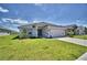 Charming single-story home with a well-manicured lawn and a concrete driveway at 1541 Leamington Ln, Winter Haven, FL 33884