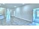 The living room is brightly lit with new tile flooring and is freshly painted at 1541 Leamington Ln, Winter Haven, FL 33884