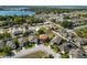Aerial shot of a residential area showcasing a home with a lake and green spaces nearby at 181 James Cir, Lake Alfred, FL 33850