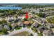 Aerial shot of a residential area showcasing a home with a lake and green spaces nearby at 181 James Cir, Lake Alfred, FL 33850