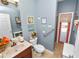Well decorated bathroom with floral decor and a charming red door leading to the pool at 181 James Cir, Lake Alfred, FL 33850