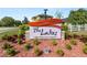 Community sign for 'The Lakes' with decorative landscaping and a modern design at 181 James Cir, Lake Alfred, FL 33850