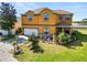 Two story home with an attached garage, a well-kept lawn, and stone accents at 181 James Cir, Lake Alfred, FL 33850