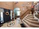 Inviting foyer with a decorative tile floor, staircase, and plenty of natural light at 181 James Cir, Lake Alfred, FL 33850